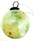 Green glass bauble with flowers inside